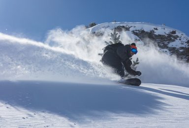 Snow Cab snowboarder riding powder