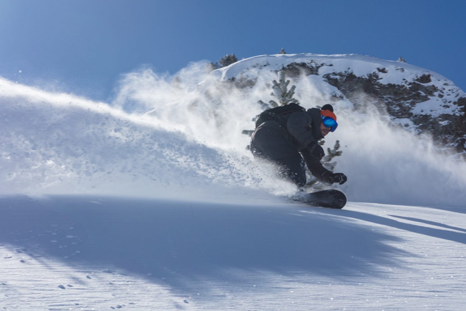 Snow Cab snowboarder riding powder